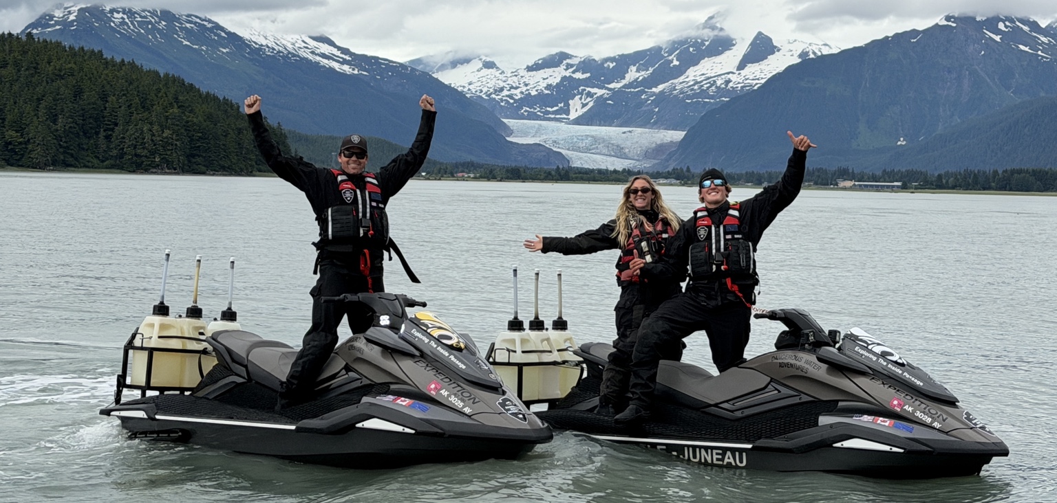 Guided jet ski group in front of glacier