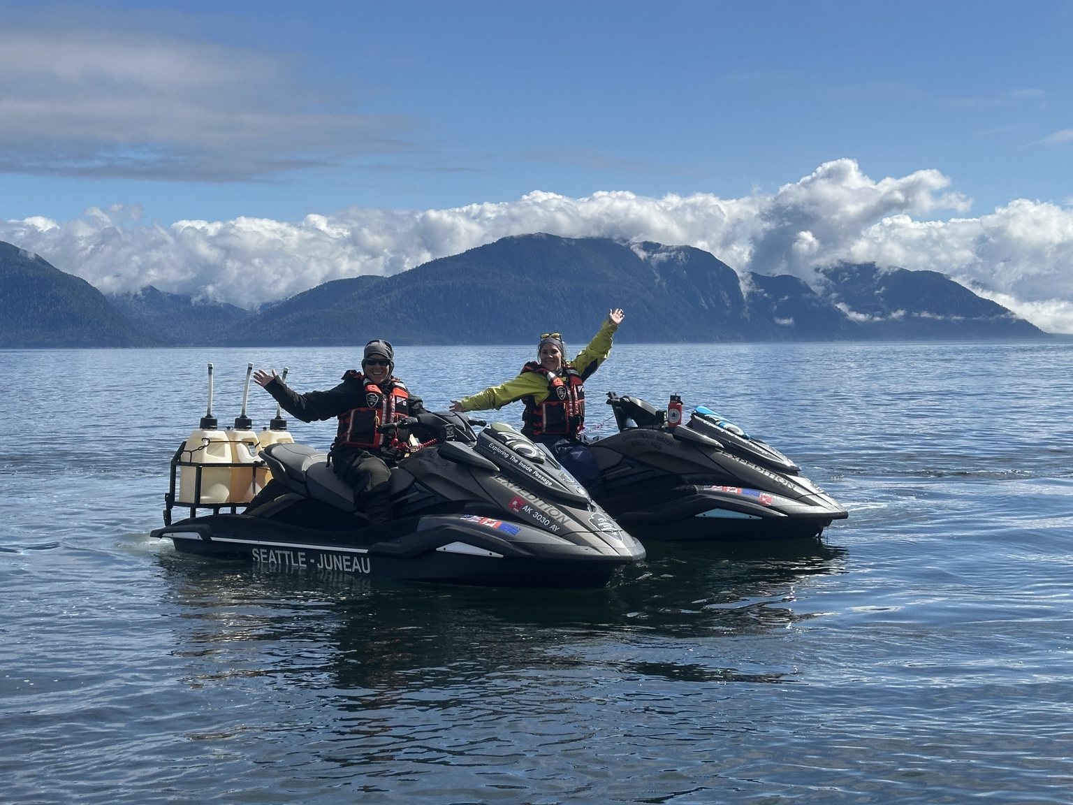 Two guests on jet skis on a sunny Alaska day